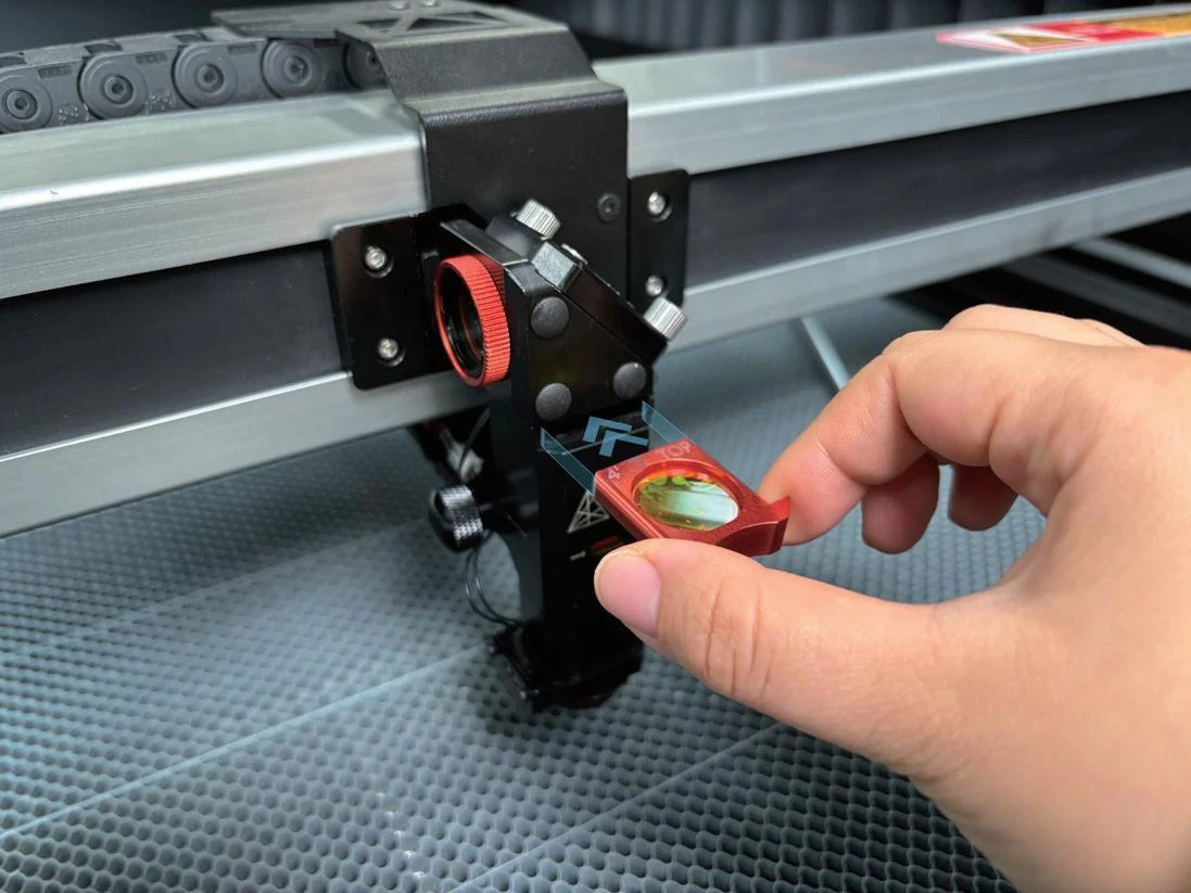Magnetic NOVA lens holder being removed by hand