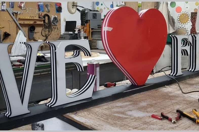 Channel letters being assembled in a workshop